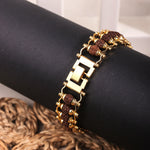 Close-up of gold clasp and Rudraksha bracelet design detail