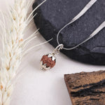 Close-up of Indonesian Rudraksha bead with handcrafted silver lotus cap