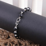 Close-up of Karungali ebony wood bracelet showing silver caps and lobster clasp