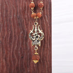 Close-up of OM Trishool gold pendant with Rudraksha beads