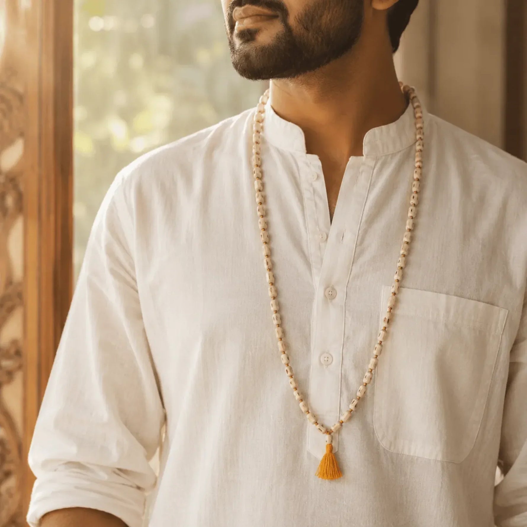 Man wearing original Tulsi japa mala with 108 beads and saffron tassel