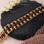 Natural Rudraksha beads with gold-tone chain bracelet, flat lay