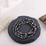 Karungali Malai on black stone display, Divymukhi ebony wood mala
