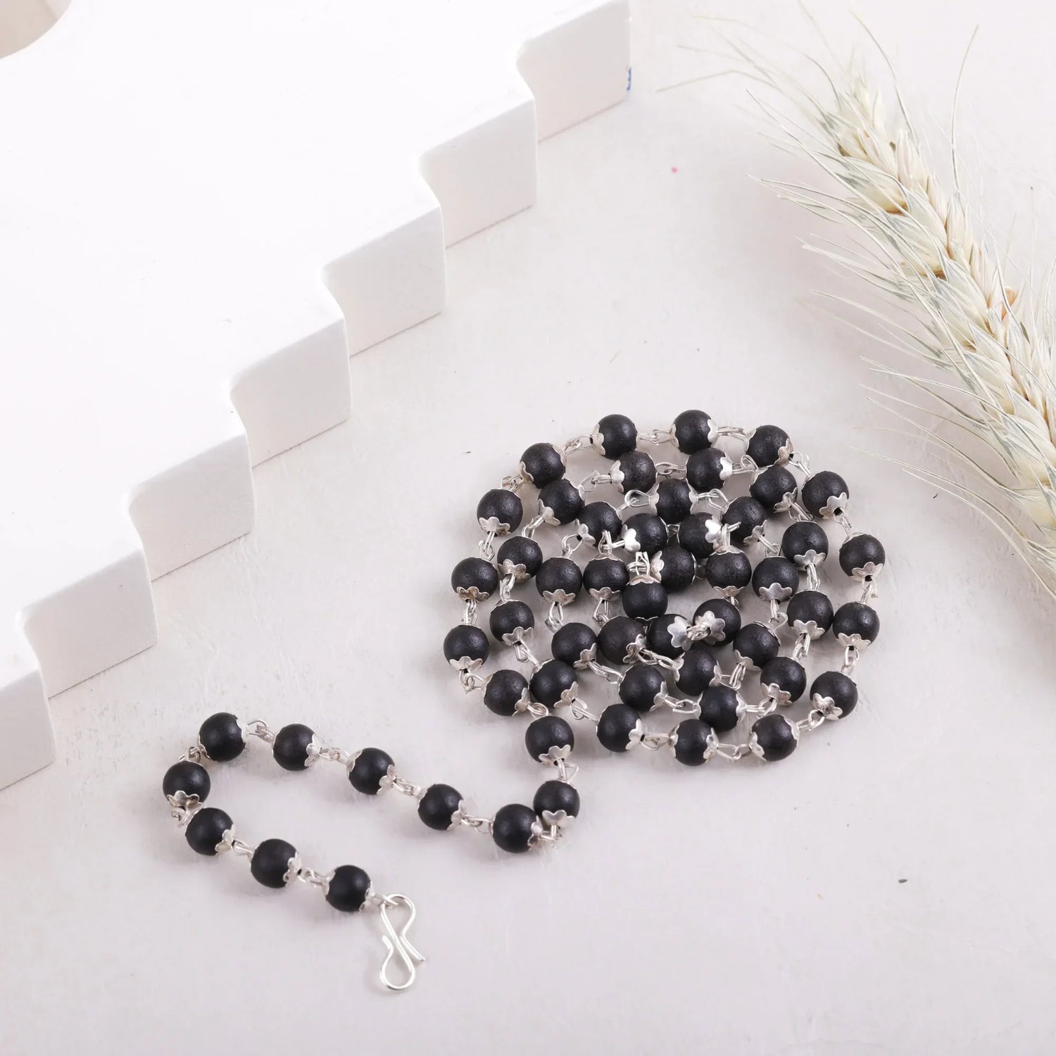 Karungali Malai ebony wood bead mala, flat lay arrangement