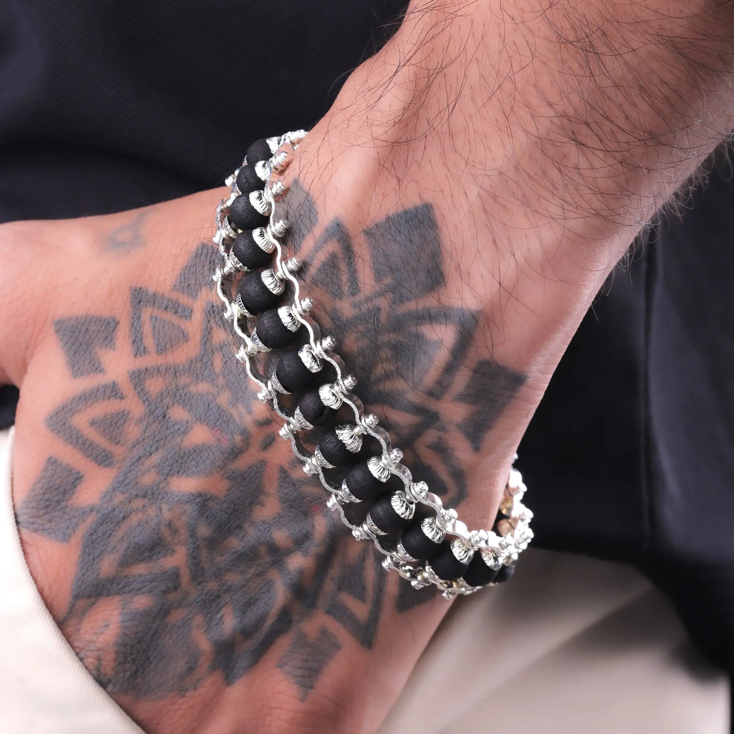 Man wearing silver-plated Karungali ebony wood bracelet